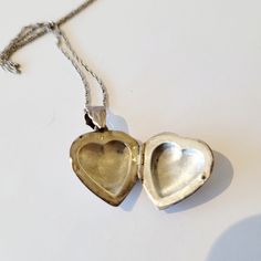 The classic double locket is sure to become a family heirloom! The hearts are individually engraved by hand. The patterns on each side are slightly different. The chasing is well executed. The sterling silver chain is twenty two inches long with a simple ring clasp. The locket is one inch long with a half inch bale, perfect for a favorite photo or secret message to keep close to your heart. Please see photos for details. Please reach out with any questions. We have free shipping in the USA and will combine international shipping on multiple orders. Any shipping overages will be cheerfully refunded. Thanks for shopping with us! Double Necklace, Twenty Two, Simple Ring, Silver Lockets, Puffy Heart, One Inch, Family Heirloom, Rings Simple, Locket Necklace