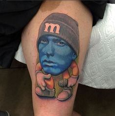 a man with a blue face and hat on his leg