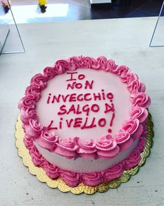 a cake with pink frosting and writing on it