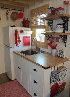 a kitchen with white cabinets and wooden counter tops