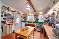 a kitchen with lots of pots and pans on the wall