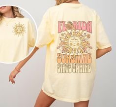 Bask in the endless summer vibes with our "Florida Sunshine State of Mind" shirt. This Comfort Colors tee captures the essence of Florida's radiant charm with a sun-kissed design on the front pocket, symbolizing the state's warm and inviting energy. Turn it around to reveal a vibrant back print. Whether you're strolling along the beach or lounging under the palm trees, this shirt is your perfect companion for soaking up the sun in true Floridian style.  * Q U I C K * F A C T S * ✺ The Comfort Colors 1717 tee is made with medium fabric consisting of high quality, 100% ring-spun US cotton for long-lasting comfort. ✺The relaxed fit, crew neckline. ✺The pre-shrunk fabric ensures a consistently great fit. ✺Made using 100% US cotton that is ethically grown and harvested.  ✺The unisex soft-style Summer Short Sleeve Shirt With Front Print, Spring Beach Shirt With Screen Print, Fun Yellow Summer Shirt, Yellow Printed T-shirt For Summer, Summer Vsco Style Tops With Funny Print, Relaxed Fit Shirt For Summer Adventures, Summer Cotton Shirt With Front Print, Spring Beach Shirt With Text Print, Yellow Summer T-shirt For Beach Season