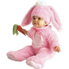 a baby dressed in pink is holding a flower and wearing a bunny costume with the words ebay on it