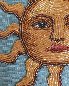 a close up of a piece of art made out of beads