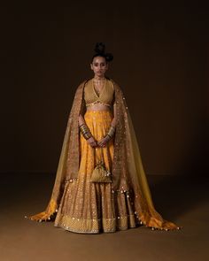 KASUNDI LEHNGA: this lehnga is made in a plush summer silk with 12 kind of flowers printed all over the base, placed in a geometric manner, and is bound with an intricate geometric border. Its hand embroidered in small mirror and sequin embroidery . The blouse is printed in small geometric pattern, then embridered with square shape sequin . Ombre Dupatta is printed and embroidered on borders and has metal coin hanging detail. Fabric : summer silk + organza mustard -olive ombre Color 15 DAYS Deli Ombre Dupatta, Small Geometric Pattern, Yellow Ombre, Small Mirror, Geometric Border, Sequin Embroidery, Small Mirrors, Have Metal, Ombre Color