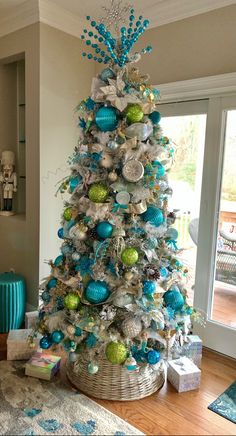 a blue and silver christmas tree in a living room