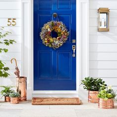 a blue front door with a wreath on it