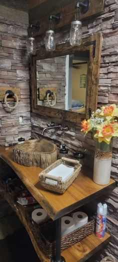 a rustic bathroom with stone walls and wood accents