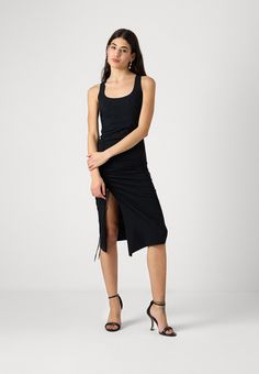 This jersey dress characterized by essential lines features a distinctive asymmetrical neckline that gives the garment a modern and seductive allure. Close-fitting with split opening and length at the knee. Technical stretch jersey Close-fitting Length below the knee The model is 1.76 m tall and wearing a size 40/XS/0 (IT) 2A2788-JZ26 Jumpsuit Jeans, Asymmetrical Neckline, Blouse Pants, Knit Vest, Shop Swimwear, Blazer Dress, Jersey Dress, Men's Collection, Jeans Dress