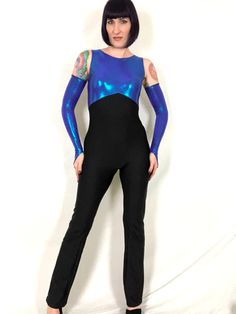 "Vintage 80s 90s Blue Purple Metallic Iridescent Lamé Dance Costume Jumpsuit! Features: - one piece stretchy spandex jumpsuit - top is composed of blue-purple iridescent metallic lamé - stretchy black spandex bottoms - back nylon zipper - 2 of these in stock; one comes with the matching gauntlet gloves, the other does not (price is reflected) Excellent condition! Bust: 30\"- 36\" Waist: 27\"+ Hips: 36\"- 40\" Rise: 23.5\" Inseam: 35\" Length: 57\"- 58\" Model is 5' 9\" and measures 33-27-39. Acc Disco Fitted Bodysuit For Costume Party, Disco Style Stretch Bodysuit For Club, Stretch Disco Bodysuit For Club Wear, Disco Style Fitted Bodysuit For Costume Party, Rave Style Stretch Unitard For Costume Party, Stretch Rave Unitard For Costume Party, Fitted Rave Unitard For Costume Party, Stretch Dancewear Bodysuit For Costume Party, Purple Fitted Jumpsuits And Rompers For Party