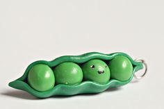 three peas in a green pea pod on a white background