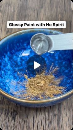 a blue bowl with gold flakes in it and the words glossy paint with no spirit