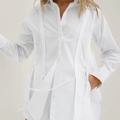 This Women's Summer French Lapel Tie Long Sleeve Shirt and Shorts Set is made from 80% polyester and 20% cotton, ensuring both comfort and breathability. The shirt features a lapel collar and tie detail, embodying French elegance. The white fabric has a slight sheer effect, adding a touch of sensuality and style. The shorts complement the shirt perfectly, creating a simple yet chic look suitable for spring and summer. Ideal for vacations, daily casual wear, festive events, and commuting, this ve Spring Shirt With Lapel Collar For Daywear, Spring Lapel Collar Shirt For Daywear, Spring Daywear Shirt With Lapel Collar, Summer Shirt With Lapel Collar For Daywear, Casual Tie Waist Blouse For Daywear, Cotton Tie Waist Tops For Daywear, Cotton Tie Neck Blouse For Work, Spring Loungewear Shirt With Spread Collar, Long Sleeve Cotton Blouse With Tie Waist