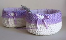 two baskets with lavender and white trims on the sides, one has a purple bow