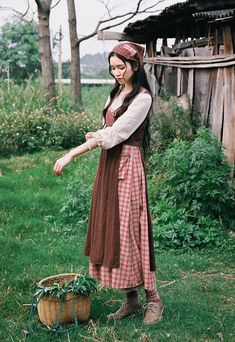 Early 19th century inspired village dress for everyday chores. This faux multi-layered dress features a white blouse part with a scoop neckline and three-quarter blouson sleeves, and a pinafore dress with plaid and ditsy floral patchwork layers. We've deliberately designed the floral patchwork to slant towards one side and attached it with an adjustable lace-up. There's a little pocket dangling at the waist to keep your phone or other knick-knacks. Full knit plaid skirt and partial linen brown s Pioneer Inspired Outfits, Victorian Peasant Clothing, House Keeper Outfit, Patchwork Dress Outfit, Cottagecore Prairie Dress For Gatherings, Fall Cotton Peasant Dress, Cotton Peasant Dress For Fall, Cotton Cottagecore Prairie Dress For Fall, Cottagecore Style Cotton Vintage Dress For Fall