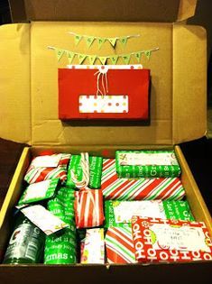 an open box filled with lots of wrapped presents