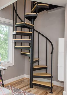 a spiral staircase with the words loft & attic stairs on it in front of a window