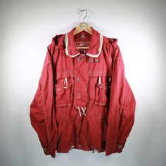 Beautiful blouson in size L from Oil Company. Really nice piece! Basic color red. Has 2 practical side pockets & zipper. Additionally cool chest pockets. Without hood. Without shoulder pads. 100% cotton. You can find more blousons, bomber jackets and other vintage clothes in our Etsy shop. If you have any questions, just write to us! Your soul & style from Berlin P.S.: Our clothes are vintage, so not new. We list defects that go beyond expected signs of wear (e.g. stains, missing buttons, holes, Casual Parka With Adjustable Hood For Urban Adventures, Winter Cotton Hooded Jacket With Multiple Pockets, Red Cotton Hooded Jacket With Pockets, Urban Cotton Hooded Jacket For Outdoor Activities, Red Cotton Hooded Jacket For Spring, Red Parka With Pockets For Outdoor, Red Cotton Outerwear With Drawstring Hood, Red Parka With Pockets For Fall, Red Cotton Long Sleeve Hooded Jacket