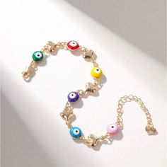 Multi Candy Colored Evil Eye Charm Bracelet Green, Red, Yellow, Purple, Blue And Pink Colored Evil Eyes With Dainty Gold Heart Charm Detailing Gold Chain So Gorgeous & Chic Most Beautiful Gift Dimensions In Last Photo New - Perfect Condition Valentine’s Day Love Gift Colorful Rainbow Multicolor Copper Trendy Gorjana White Gold Silver Metallic 14k Adinas Jewels Swarovski Eye Yellow Gold Black Pupil Diamond Accented Baublebar Mejuri 14k Link Gorjana Alex And Ani Hands Cz Shashi Mejuri Coach Mezzo Trendy Multicolor Charm Bracelet, Adjustable Metal Evil Eye Bracelet, Summer Metal Bracelets As A Gift, Summer Metal Bracelets As Gifts, Summer Metal Bracelets For Gifts, Summer Metal Bracelet For Gift, Summer Gift Metal Bracelets, Metal Evil Eye Bracelet For Gift, Metal Bracelets With Heart Beads