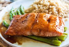 salmon and asparagus on a plate with rice