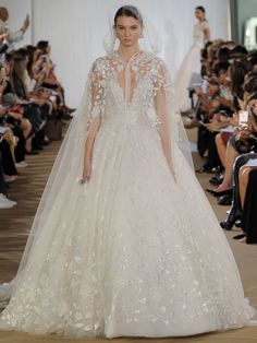 a model walks the runway in a wedding dress