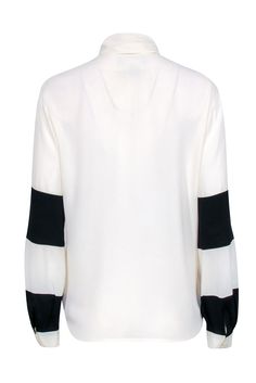 Go classic and chic with this neutral blouse by Louis Feraud! A silk blend button front boluses with color blocked sleeve details featuring black stripes. Pair with your wide leg black pants, a sleek sling back heel, and a colorful leather tote for a posh and polished everyday look! Size 4 60% Acetate, 40% Silk Button front Unlined V-neckline Long sleeve Color blocked design Tie at neckline Bust 40" Waist 40" Shoulder to hem 26" Sleeve length 24" Neutral Blouse, Wide Leg Black Pants, Louis Feraud, Black Wide Leg Pants, Colored Leather, Sling Back, Sleeve Detail, Black Stripes, Everyday Look