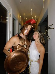 two women dressed in roman costumes posing for the camera