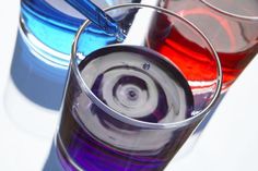 two glasses with different colored liquids in them