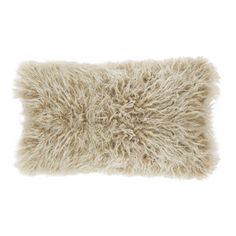 a white pillow with shaggy fur on the front and back of it, against a white background