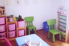 a child's playroom with toys and storage bins