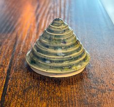 a small ceramic cone sitting on top of a wooden table