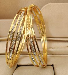 This elegant set of 2, 1 gram gold-plated bangle bracelet set is perfect for everyday wear. Perfectly light-weight, these bangle designs are crafted from 1 gram gold. Ideal for gifting someone special, this stylish set is also an excellent value for money. Gold Bangle Set, American Diamond Necklaces, Oxidized Necklace, Bracelets Design, Bangle Ring, Gold Plated Bangles, Bangle Bracelet Set, Bangle Designs, Jhumka Earrings