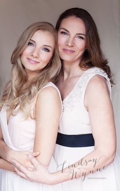 two beautiful women hugging each other in front of a white background with the caption's name on it