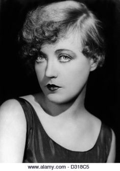 an old black and white photo of a woman with lipstick on her lips looking at the camera