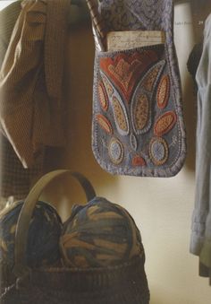 an old purse hanging on the wall next to other items