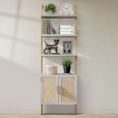 a shelf with some plants and pictures on it in an empty room next to a wall