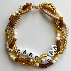 two bracelets with beads and letters that spell out caramel on the bottom one