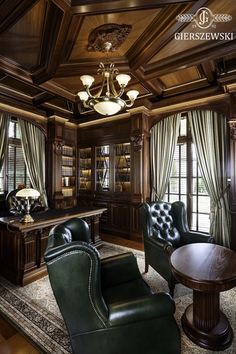 a living room filled with green leather chairs and a wooden book shelf next to a window