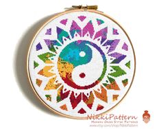 a cross stitch pattern with a yin symbol on it