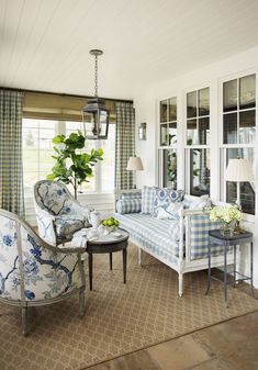 a living room filled with furniture and windows