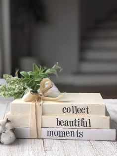 two books stacked on top of each other with a ribbon tied around the book ends