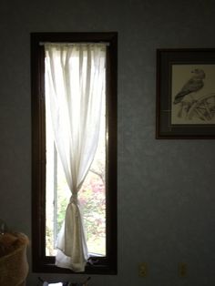 a room with a window and pictures on the wall