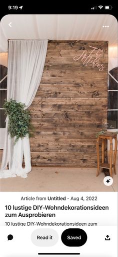 an image of a wooden wall in the middle of a room with white drapes