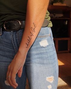 a woman with a tattoo on her arm that says, hello little one in cursive writing