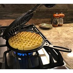 a waffle iron on top of a gas stove