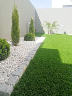 an outdoor area with grass, rocks and bushes