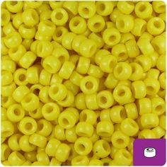 yellow plastic beads with holes in the middle