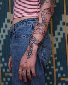 a woman with a snake tattoo on her arm