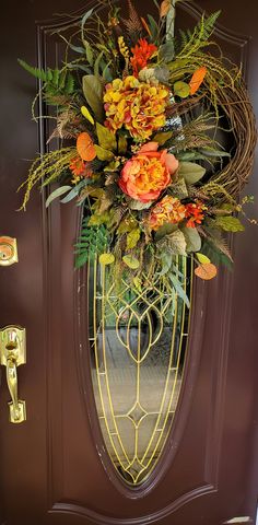 the front door is decorated with flowers and greenery for an elegant touch to any home