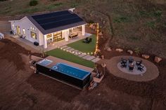 an aerial view of a house with a hot tub in the yard